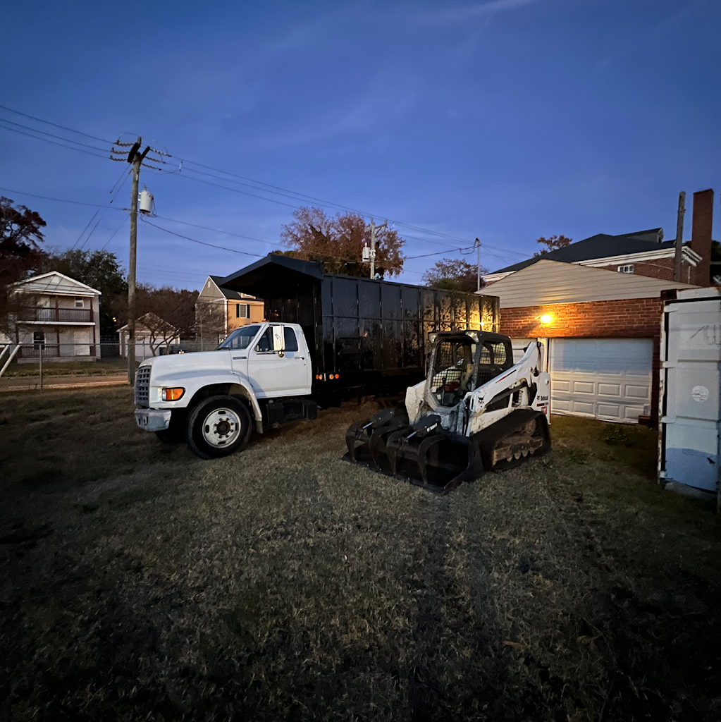 M&M Tree Service professional equipment - dump truck and compact track loader at residential job site